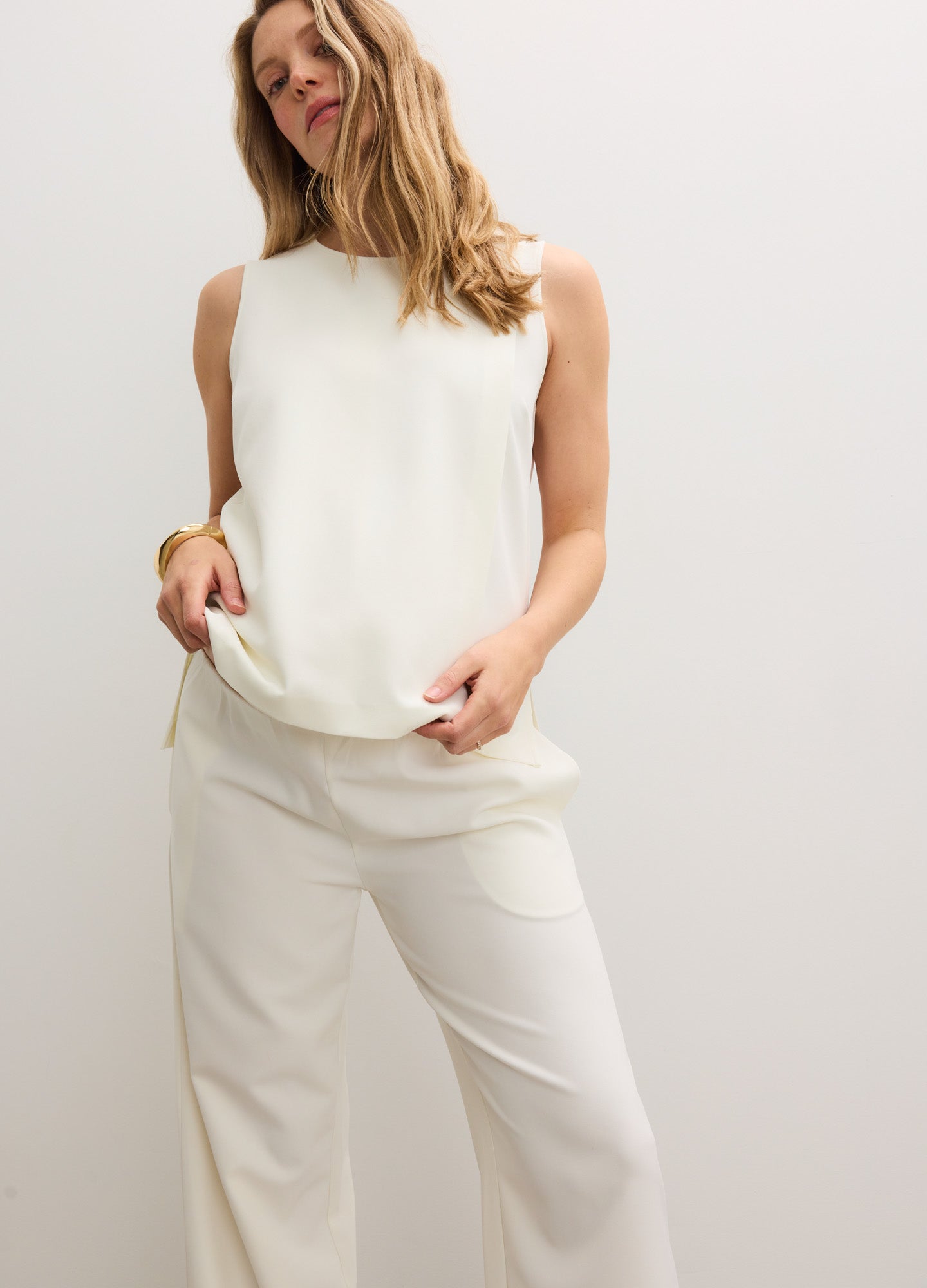 White sleeveless nursing tank with a loose, flowy fit made from soft, stretchy fabric.