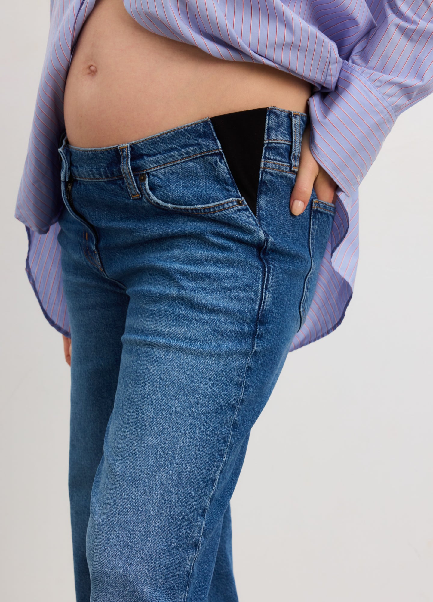 True indigo wide-leg maternity jeans with elastic side panels, worn by pregnant model.