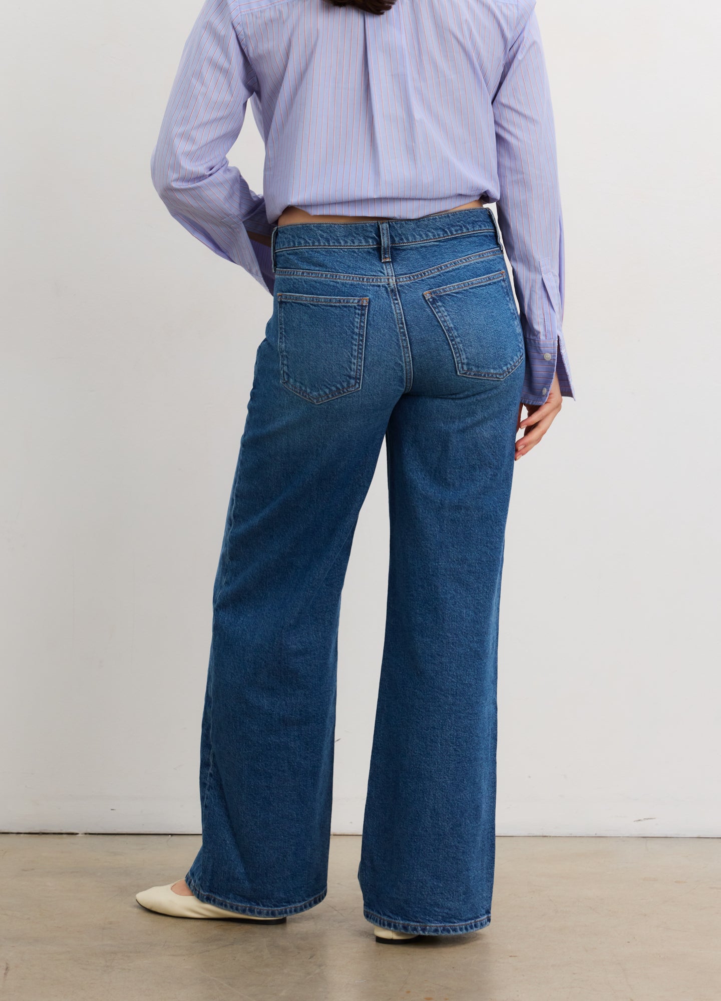 Blue denim wide-leg maternity jeans with relaxed fit and back pockets.