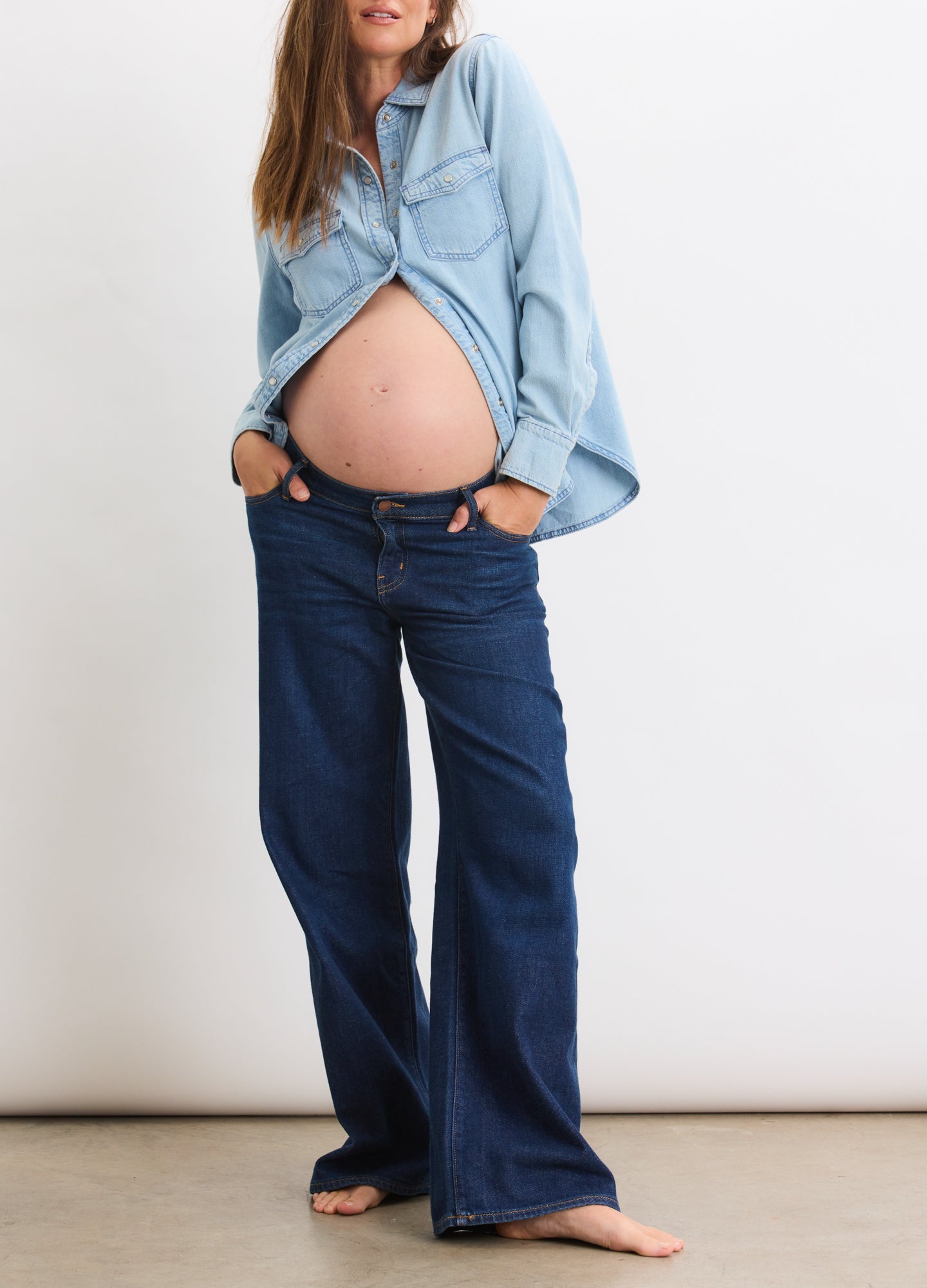 Dark blue wide-leg maternity jeans with a high stretchy waistband, worn by a pregnant model.
