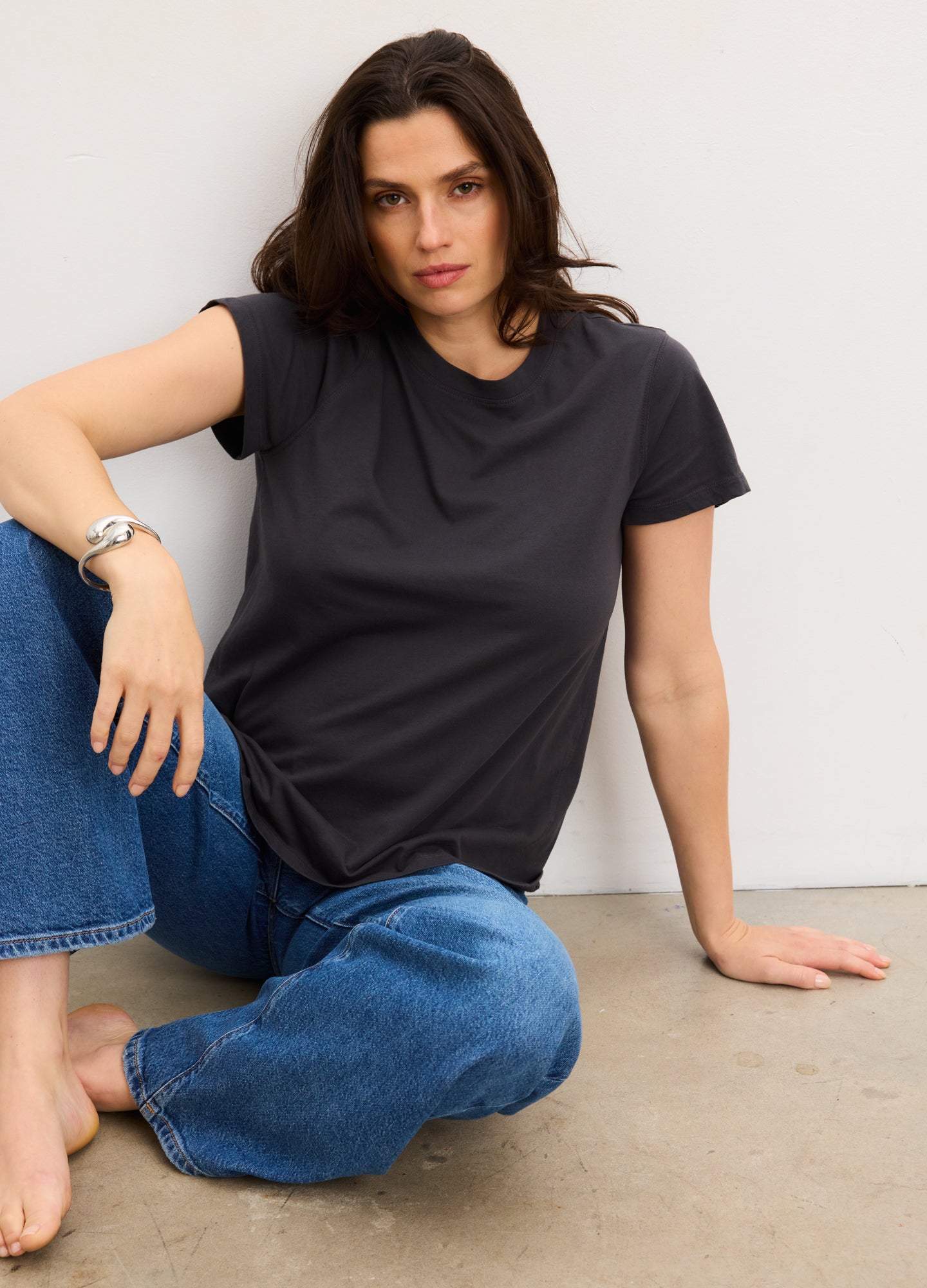 Black washed cotton short sleeve crew neck maternity t-shirt with relaxed fit on model.
