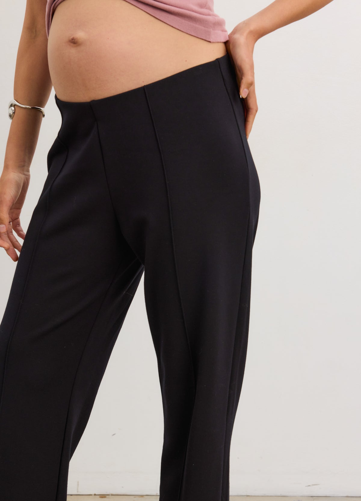 Black maternity stretch straight-leg work pants with seamed front and soft waistband panel.