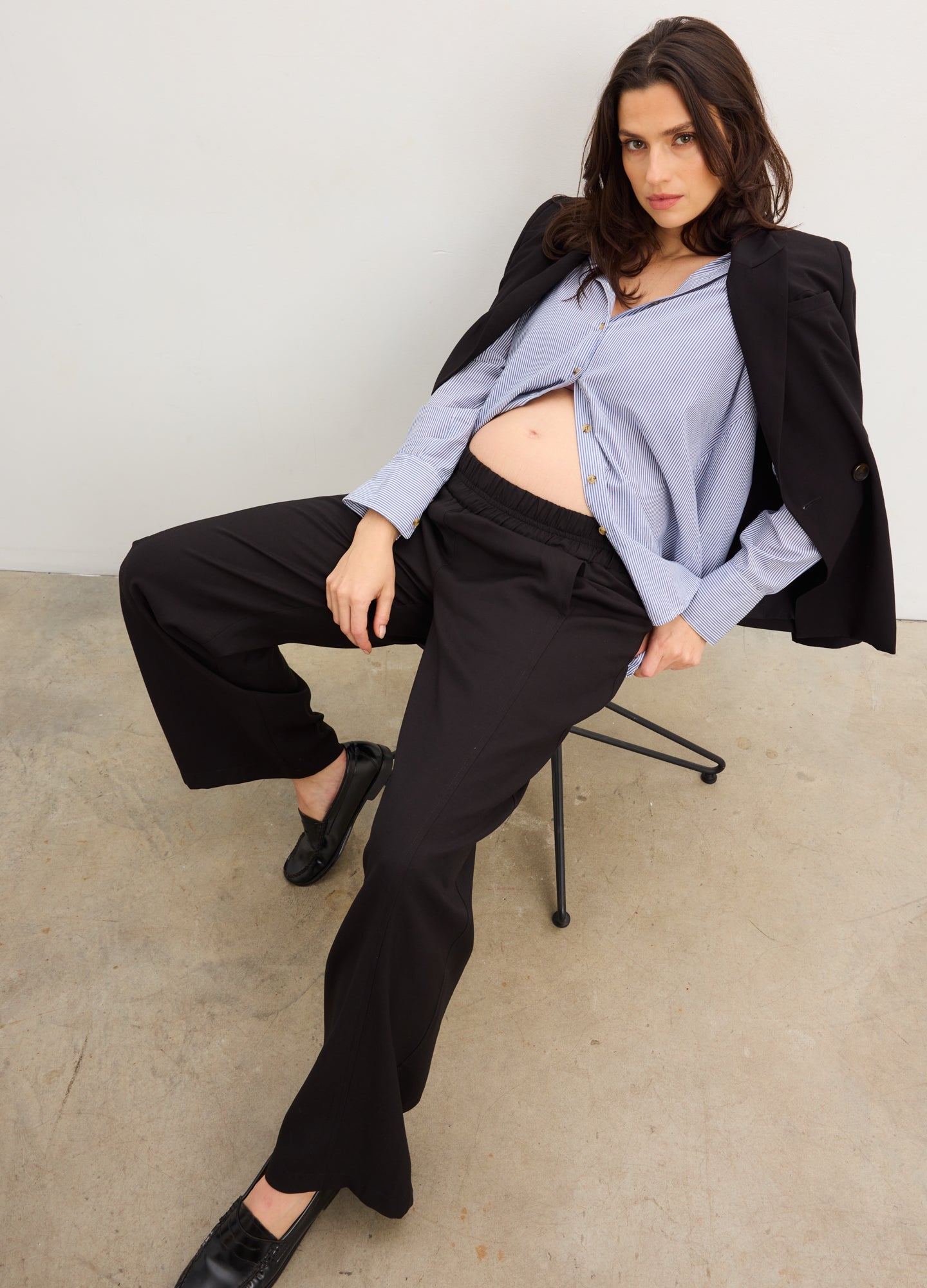 The Soft Tailored Pull On Trouser - Black soft tailored maternity trousers with a pull-on waistband, styled with a blue nursing-friendly blouse and black blazer.