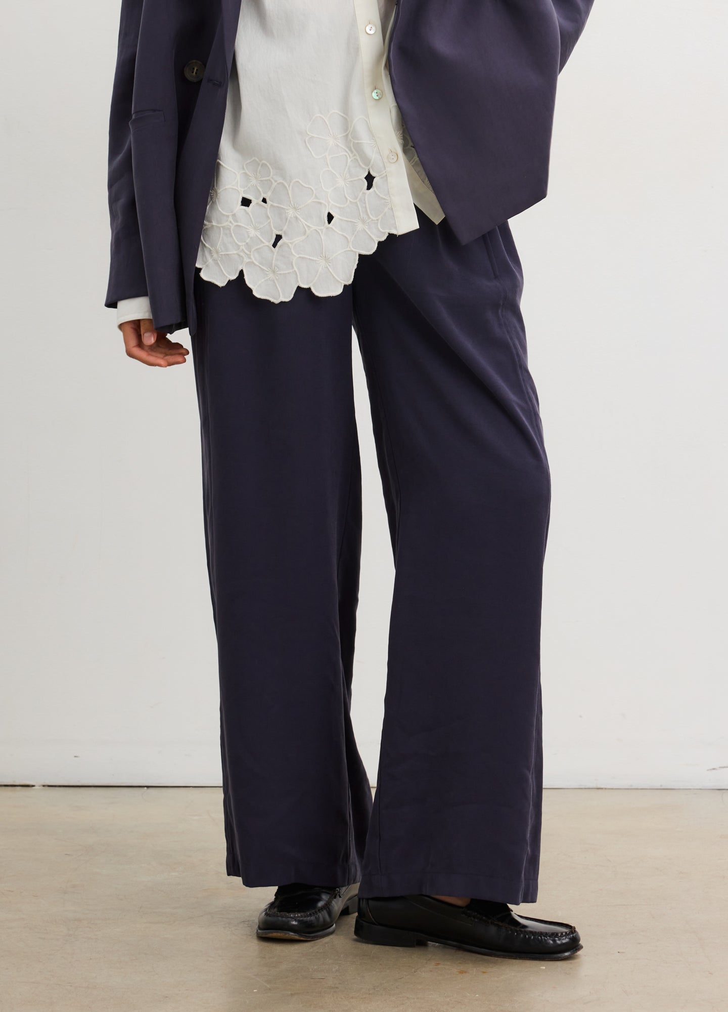 Black wide-leg maternity trousers with a pull-on waistband in soft tailored fabric.