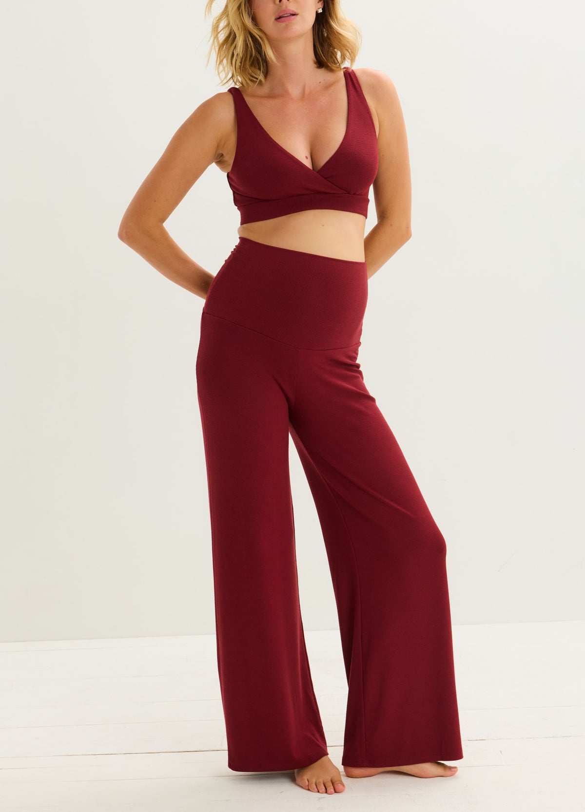 Cranberry maternity nursing bra with a deep V neckline and wide underband, paired with matching ribbed pants.