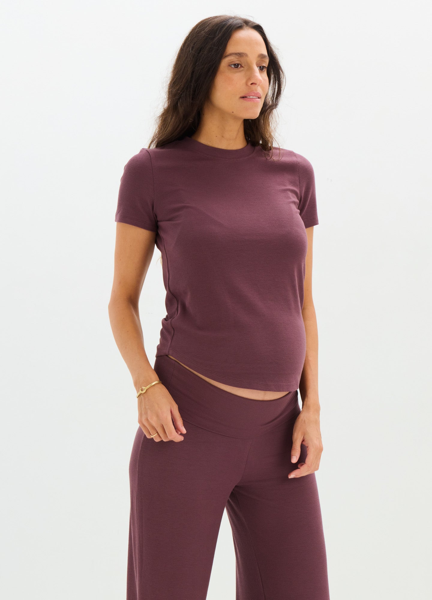 Soft ribbed maternity tee in deep plum with short sleeves and a fitted silhouette.