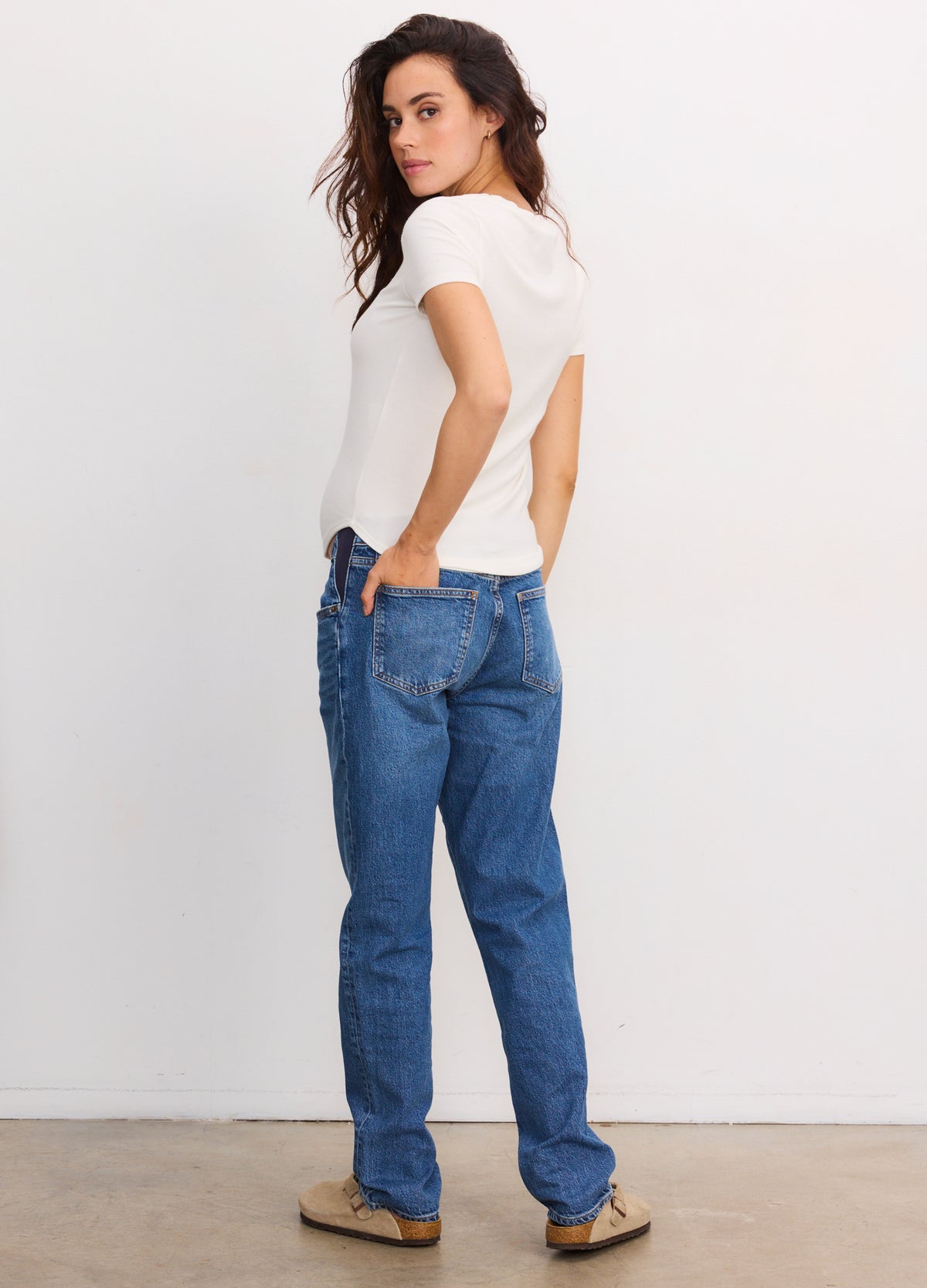 White short-sleeve ribbed maternity tee with fitted silhouette on pregnant model.