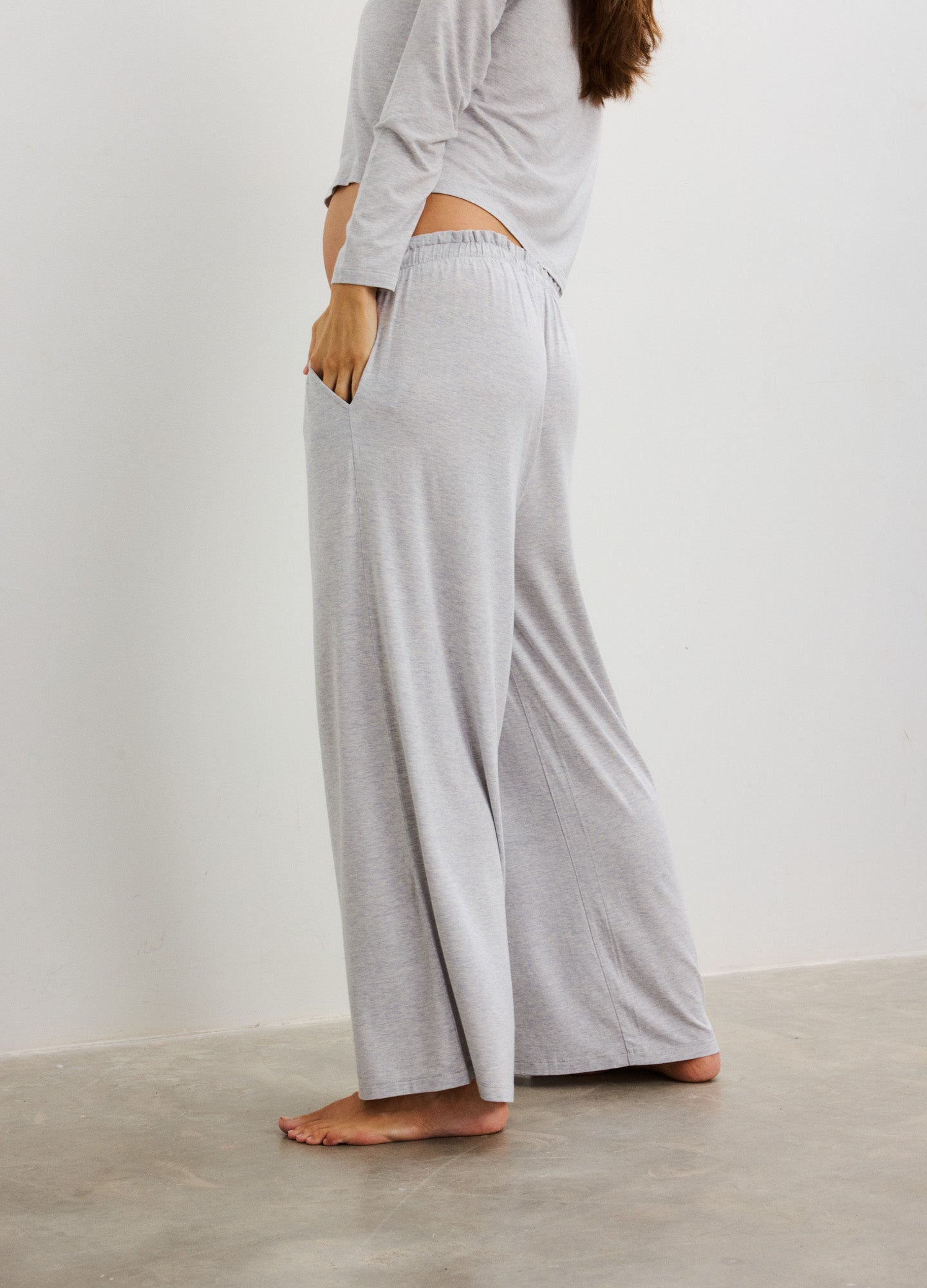 Light grey soft knit wide-leg maternity pants with a high, stretchy waistband designed for pregnant comfort.