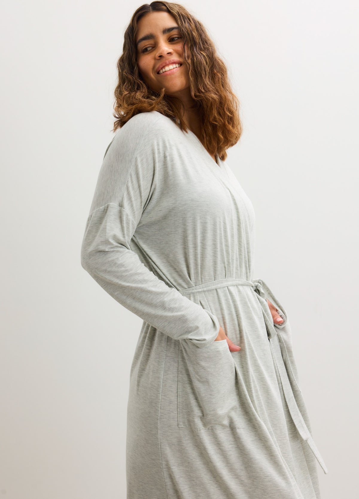 Light gray maternity robe with long sleeves, belted waist, and front pockets in soft fabric.