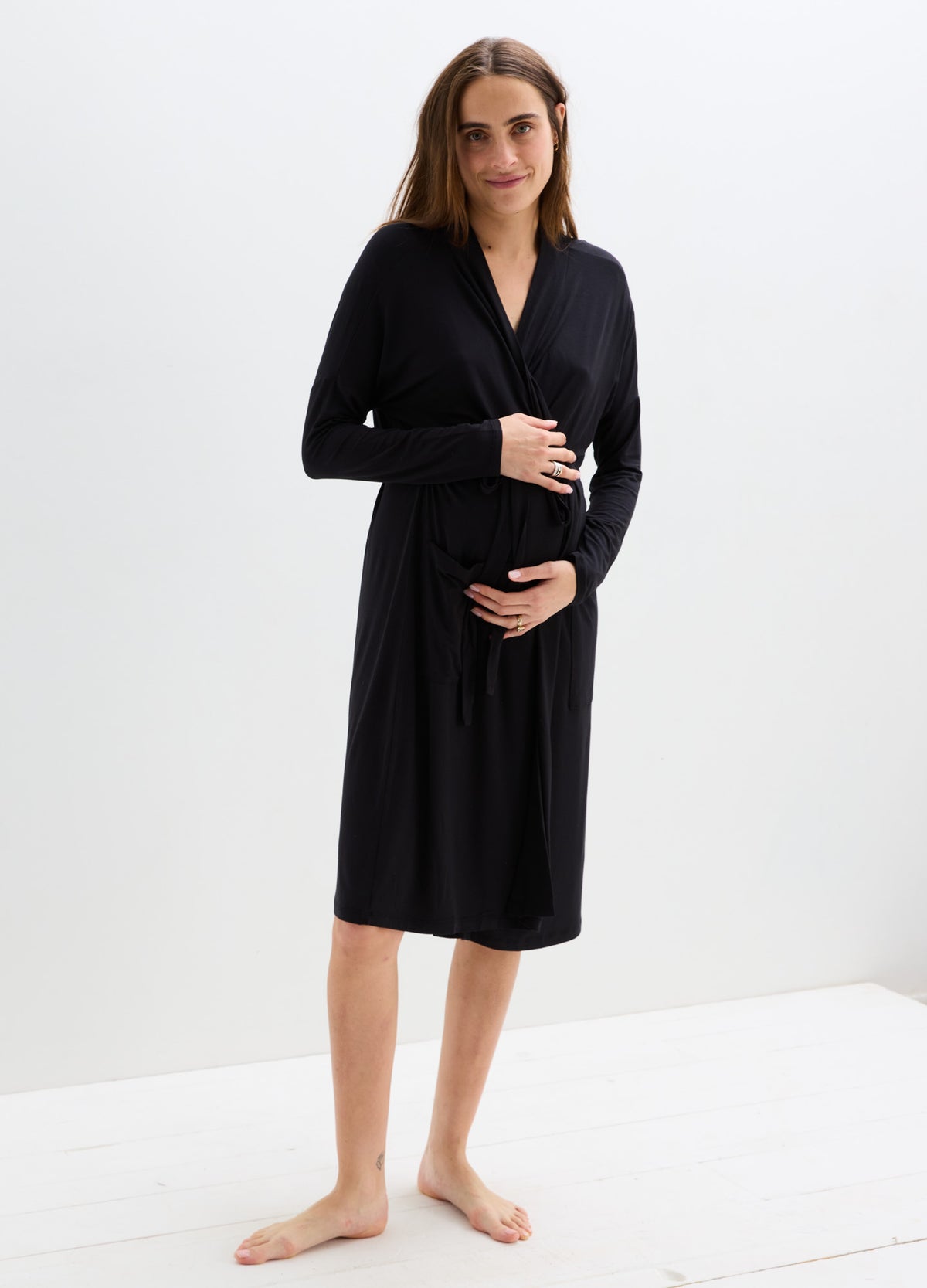 Black knee-length maternity robe with long sleeves, soft fabric, and a wrap tie belt.