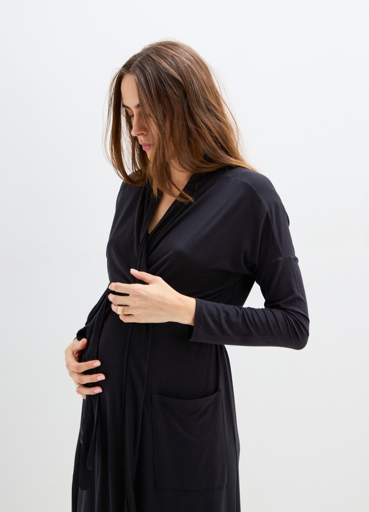 Black long-sleeve maternity robe with wrap front and front pocket, soft fabric.