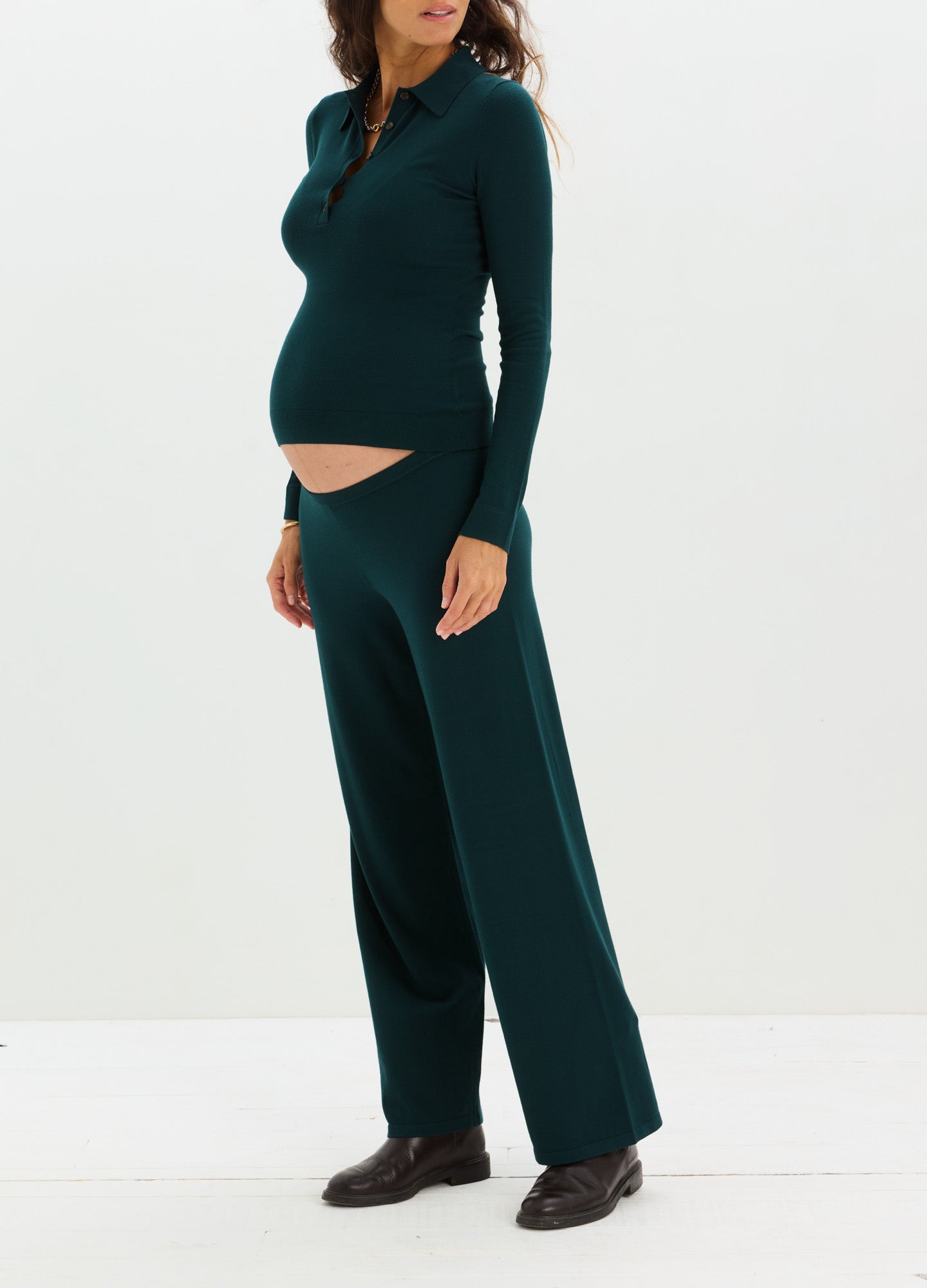 Dark green knit maternity pants with wide legs and a soft, stretchy waistband designed for pregnant comfort.