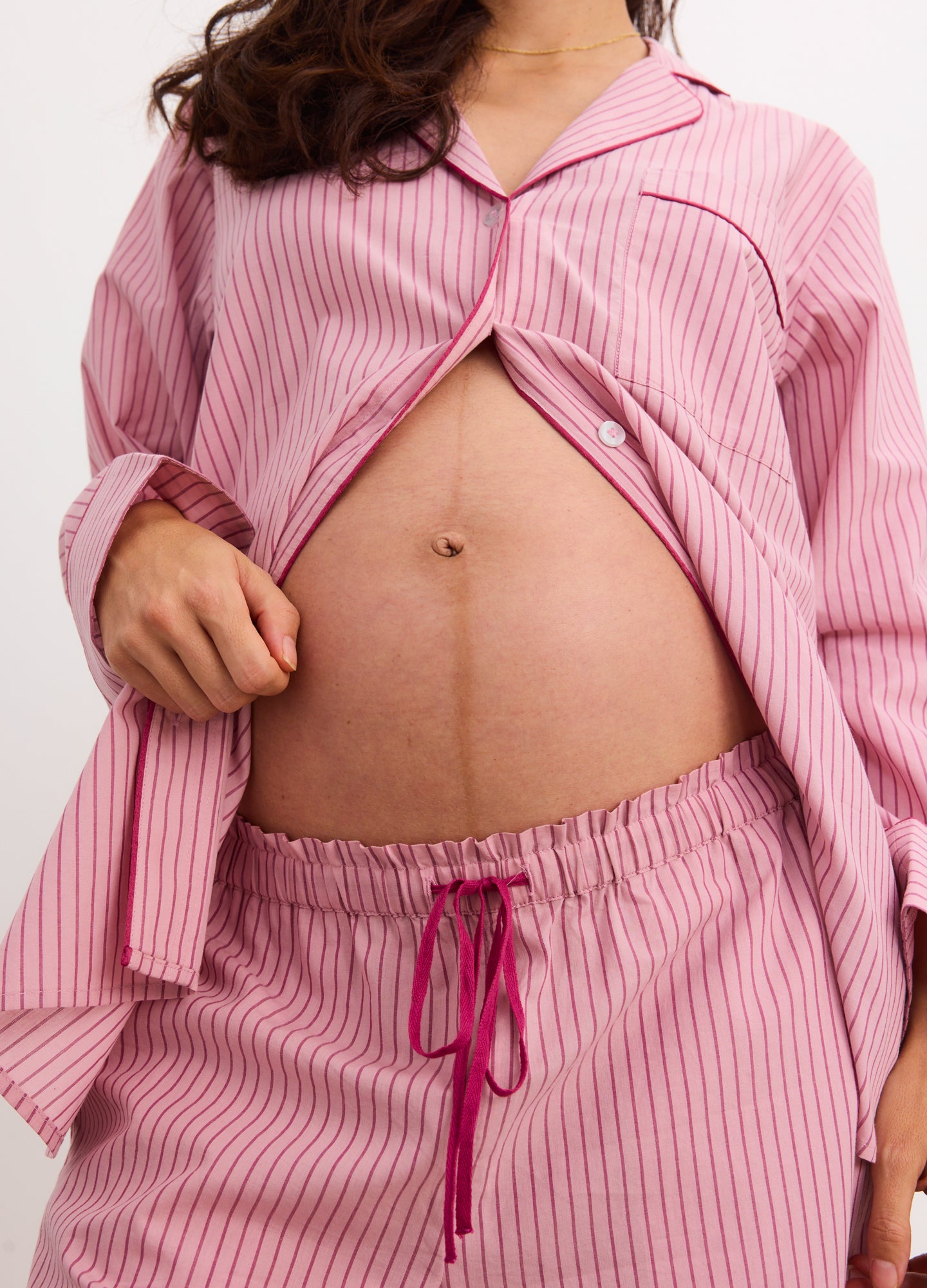 Pink and white striped cotton maternity pajama set with long sleeves and elastic waist pants.