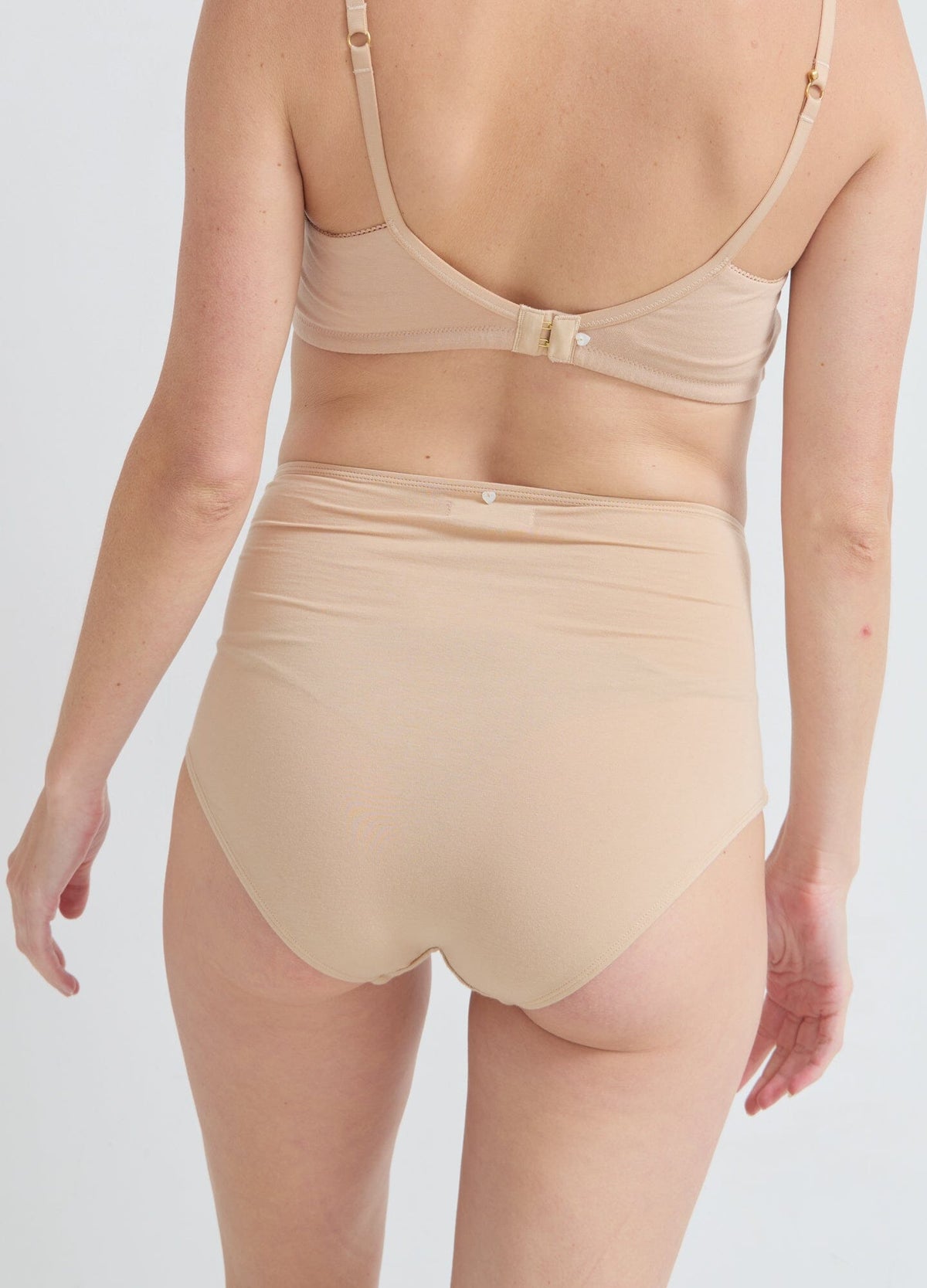 The High Tuck Brief POS - Navy rosette maternity high tuck briefs with full coverage, modeled for pregnancy and postpartum comfort.