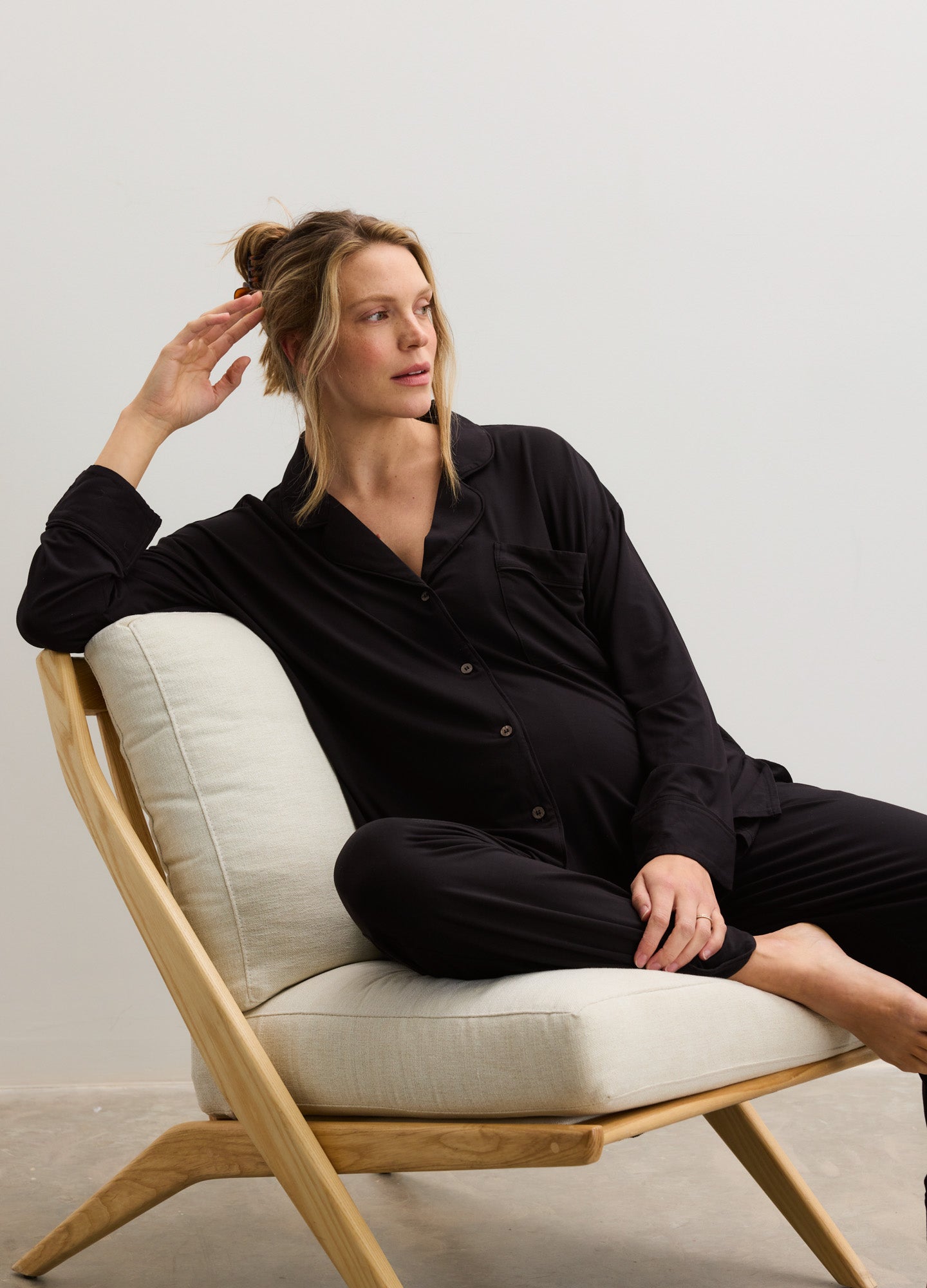 Black maternity pajama set with button-up jersey top and relaxed pants, styled for comfort.