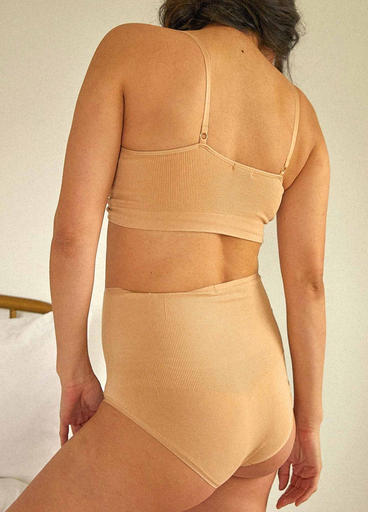 The Essential Nursing And Pumping Bra - Sand-colored maternity bra with adjustable straps designed for nursing and postpartum comfort.